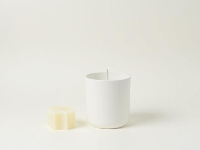 A TIMOTHY C BUCKLEY candle vessel with a sustainable refill wax insert.